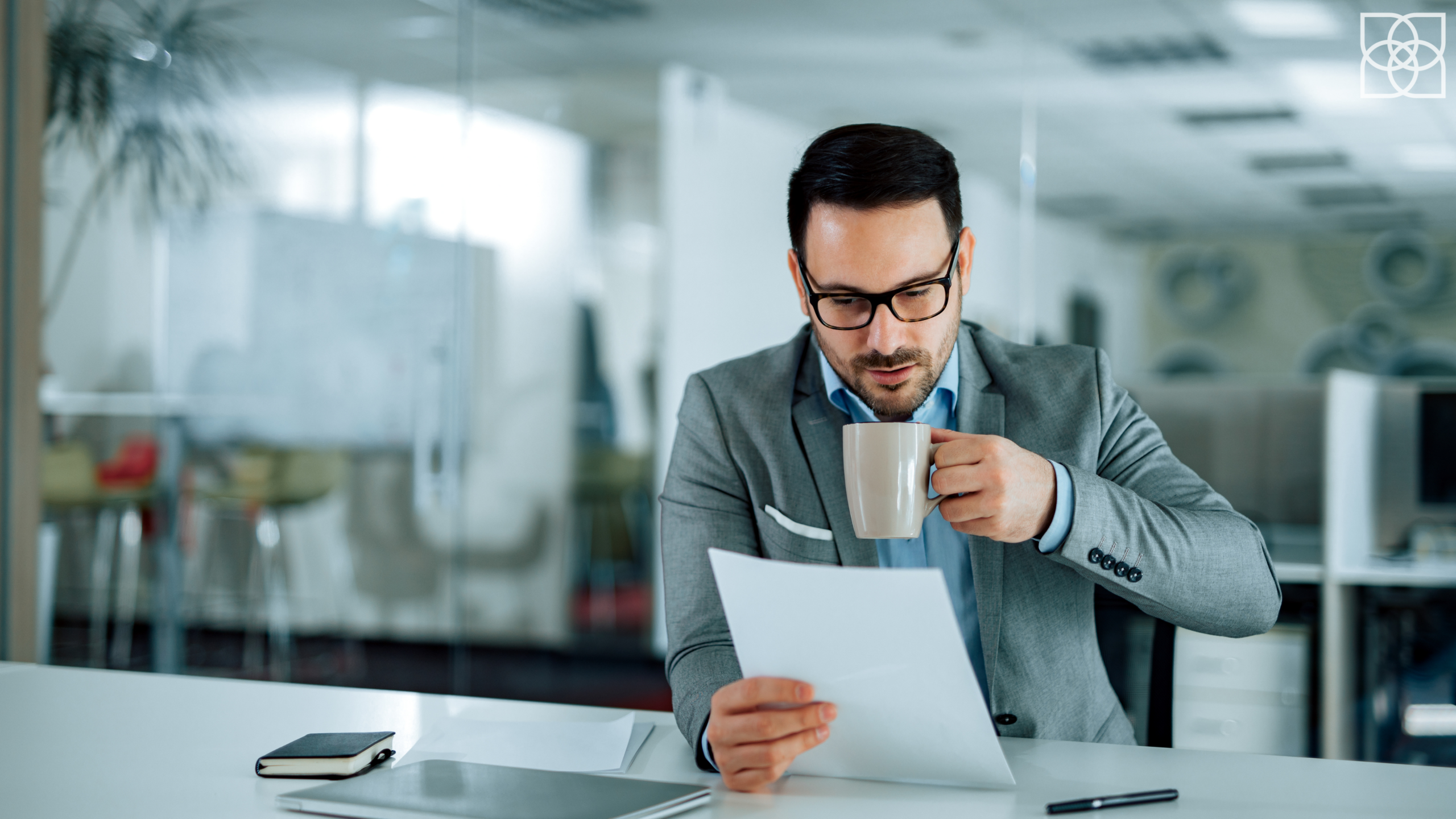 Executive reviewing career documents at office desk