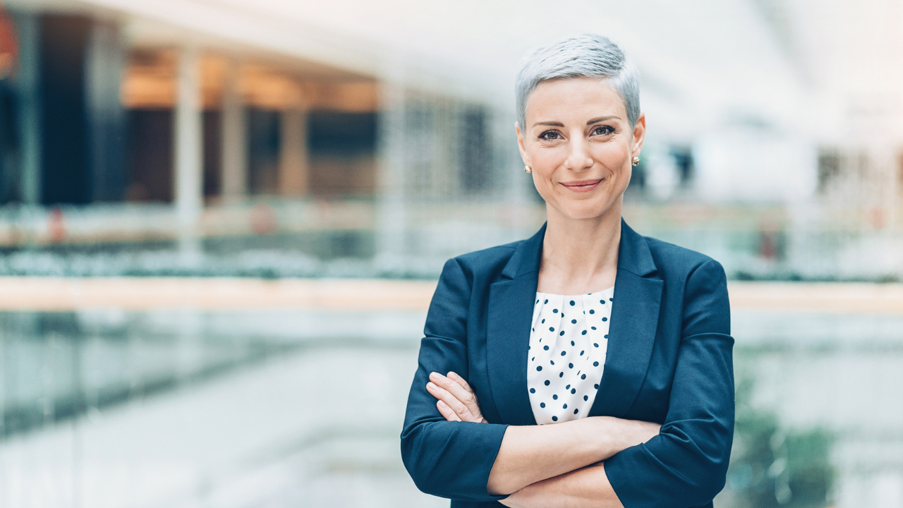 Confident executive woman standing in professional office setting