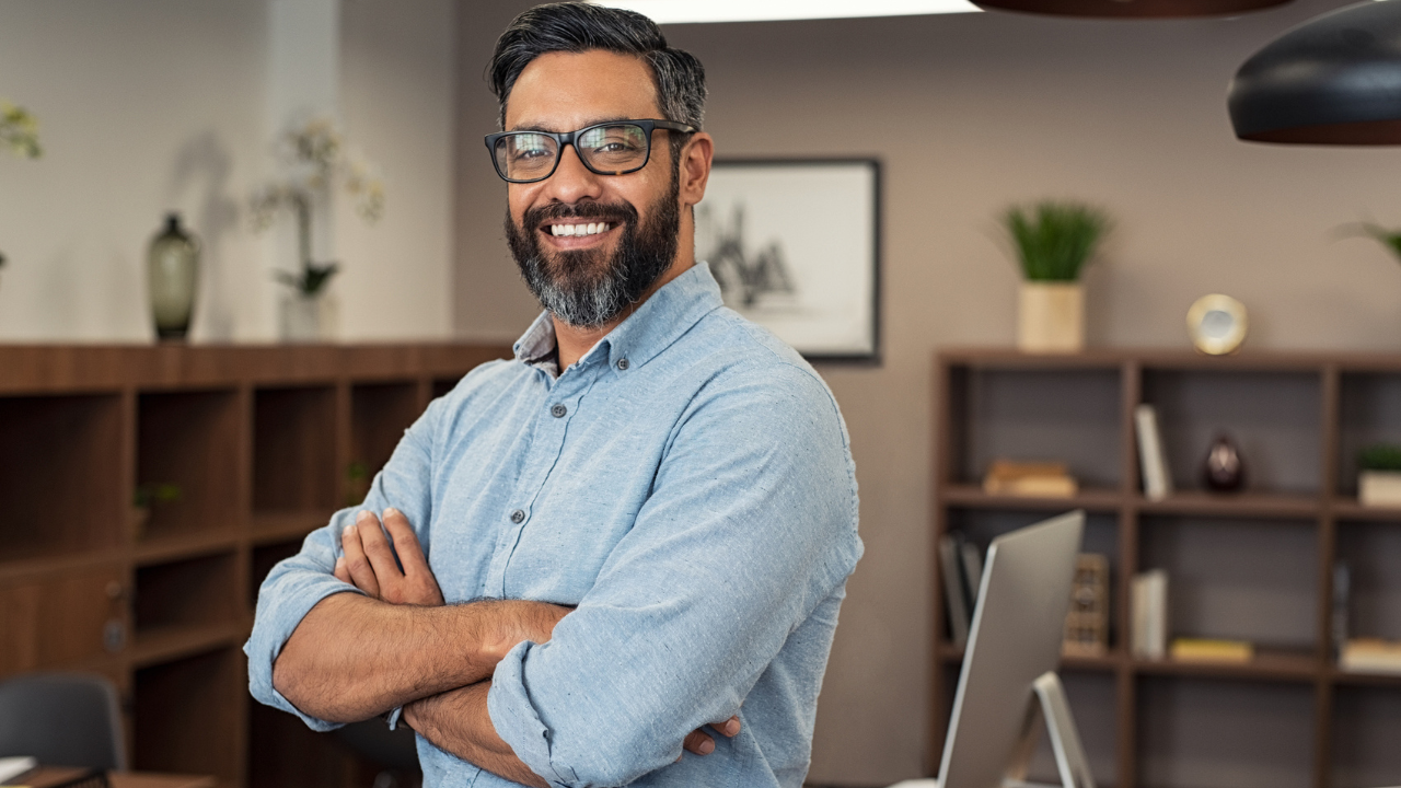 Confident professional man standing in modern office