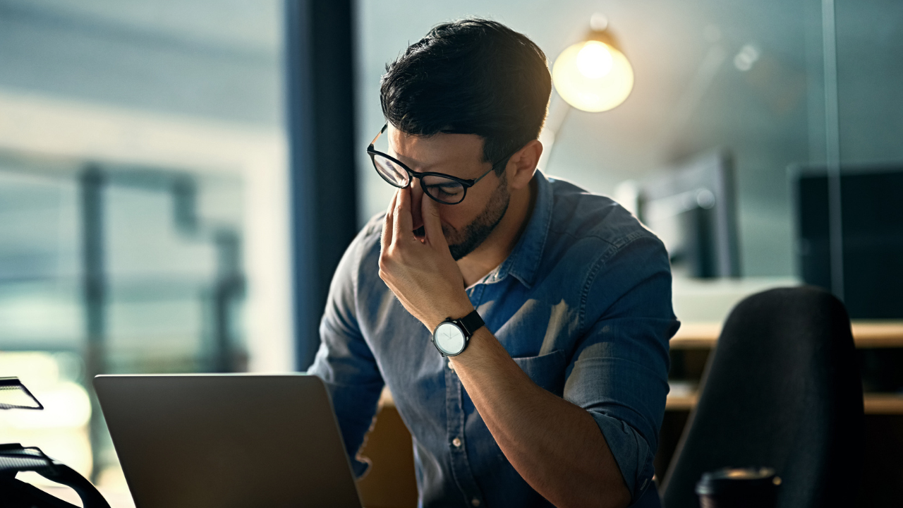 Professional man taking a phone call while working on laptop
