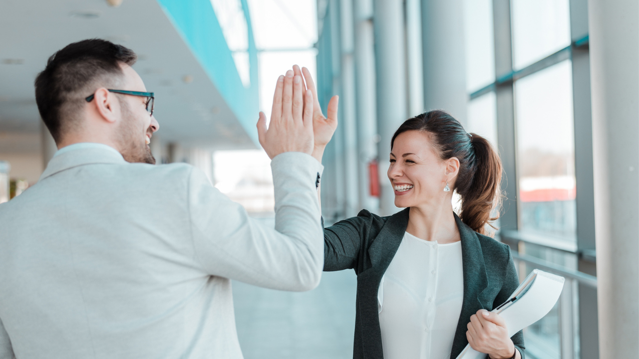 Professionals celebrating success with high five