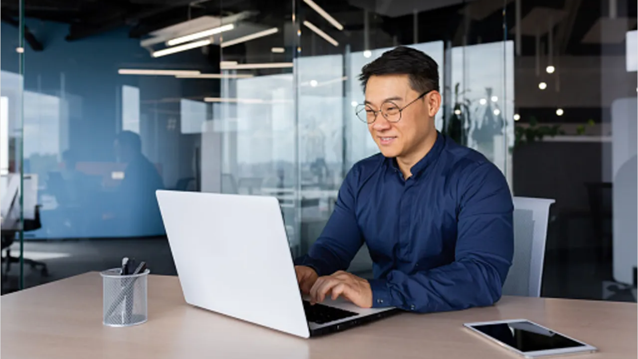 Professional working on laptop in modern office
