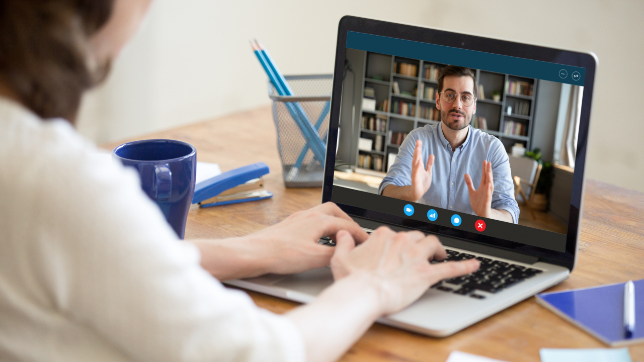 Professional attending virtual career coaching session on laptop
