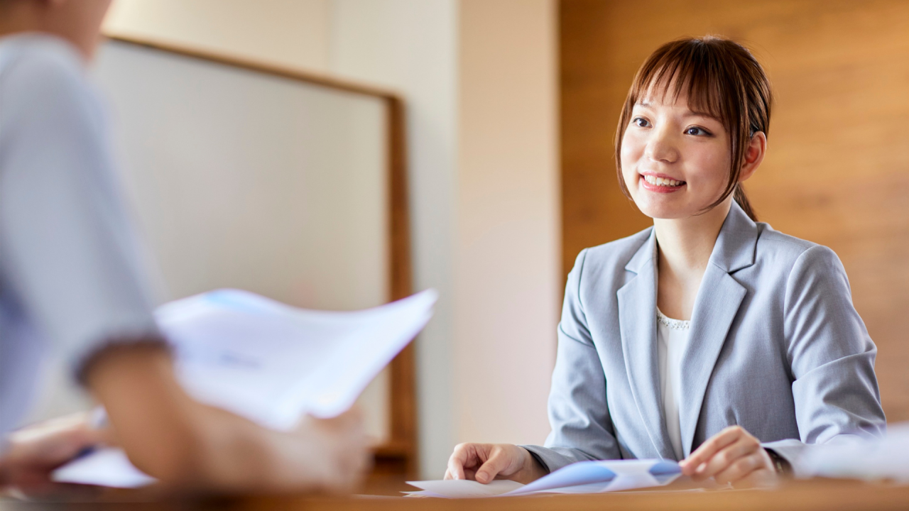 Professional woman smiling during interview preparation meeting