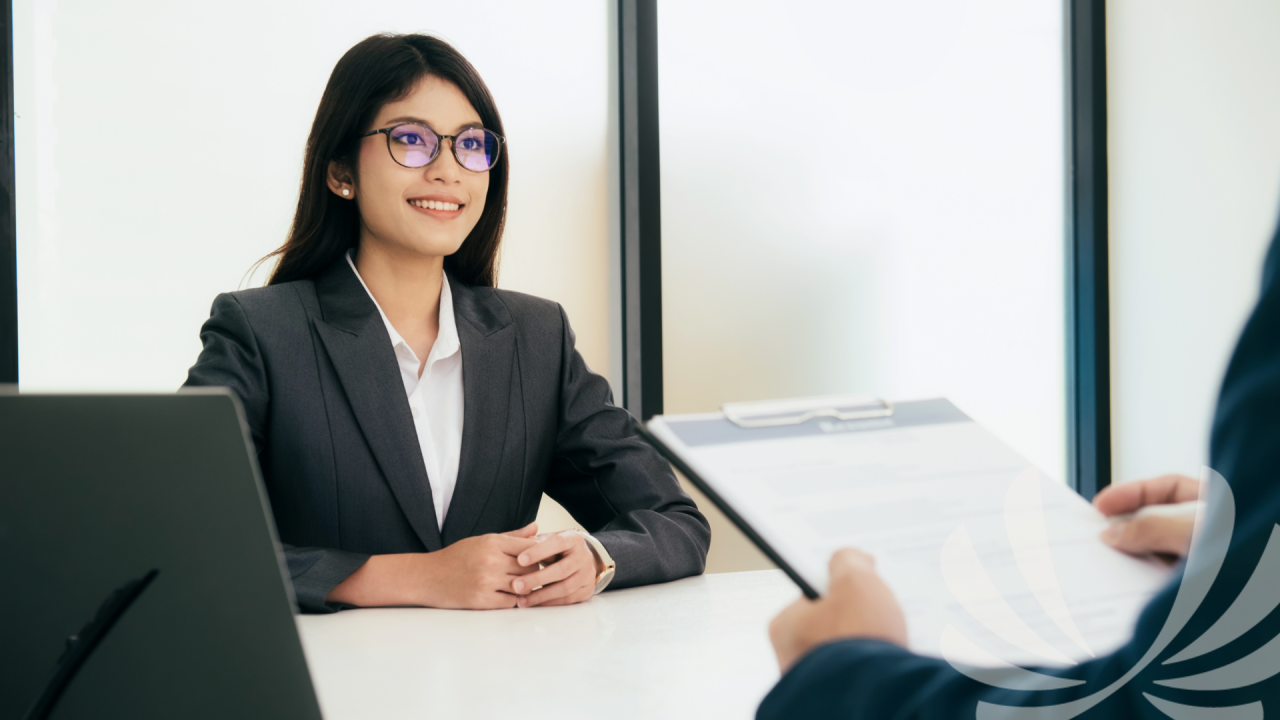 Professional woman attending an interview at office desk