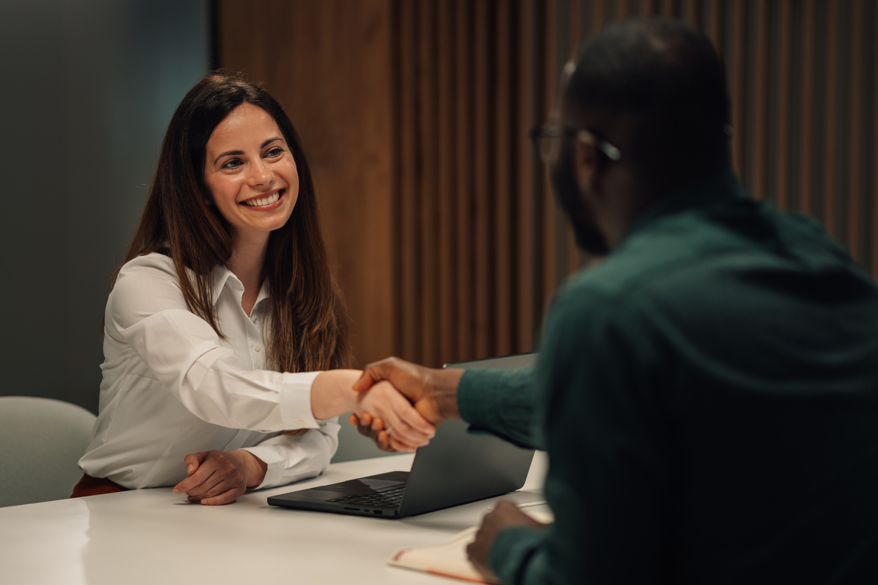 Businesspeople shaking hands after successful meeting in office